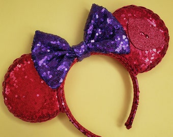 May include: Red and purple sequined Minnie Mouse ears headband with a large purple bow.