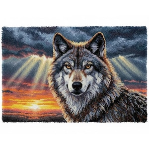 May include: A detailed textile art piece depicting a wolf against a sunset backdrop. The wolf's fur is rendered in shades of gray, brown, and white, with piercing yellow eyes. The sunset features vibrant orange and yellow hues.