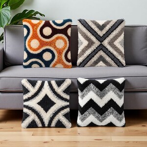 May include: Four square throw pillows with textured, tufted designs. One pillow features an orange and blue pattern, another has a gray geometric design, a third has a black and white diamond pattern, and the last has a black and white chevron pattern.