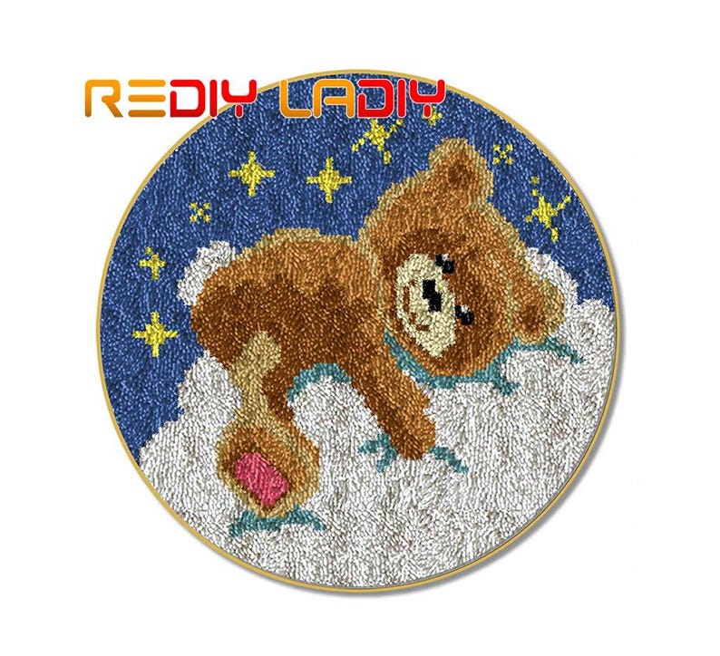 May include: A round rug with a blue background and white clouds. A brown teddy bear with a pink nose is lying on the clouds. The rug is decorated with yellow stars.
