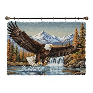 May include: A tapestry depicting a bald eagle in flight over a waterfall and lake, with a backdrop of mountains and evergreen trees. The eagle has brown wings, a white head, and yellow talons. The tapestry is mounted on a decorative rod.
