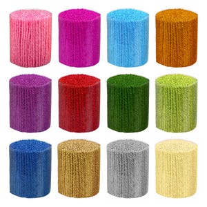 May include: Twelve spools of yarn in various colors, including pink, purple, blue, green, red, orange, gold, and gray. The spools are arranged in three rows of four.