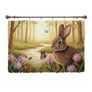 May include: A decorative tapestry featuring a brown rabbit in a forest scene. The artwork includes a stream, flowers, butterflies, and bees. The tapestry is hung from a dark bronze rod with decorative finials.
