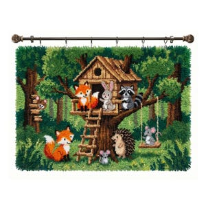 May include: A rectangular latch hook wall hanging featuring a forest scene with a wooden treehouse, a fox, a rabbit, a raccoon, a hedgehog, and mice. The textured yarn art is suspended from a dark metal rod with decorative finial ends.