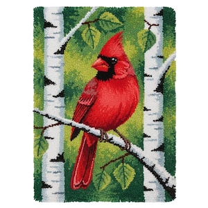May include: A vibrant, hand-hooked rug featuring a red cardinal perched on a birch tree branch. The bird has a black mask and a prominent crest. The background is a mix of green and yellow, with white birch tree trunks and green leaves. The rug is rectangular.