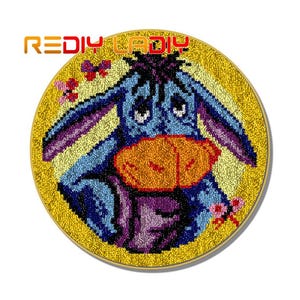 May include: A blue and purple donkey with a yellow nose and a yellow background. The donkey is embroidered with yarn and is a craft project.