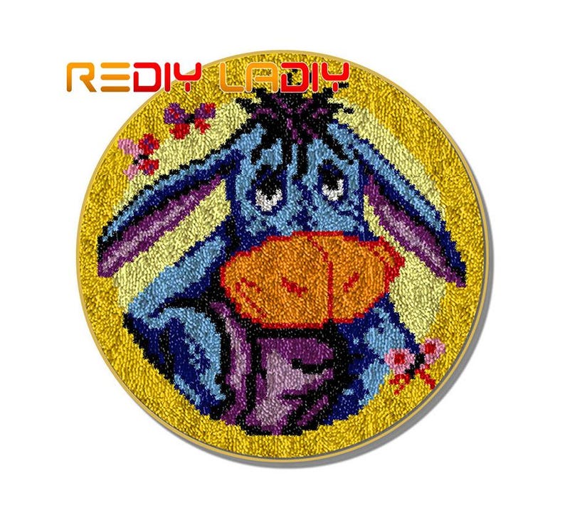 May include: A blue and purple donkey with a yellow nose and a yellow background. The donkey is embroidered with yarn and is a craft project.