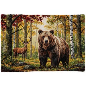 May include: A detailed rug depicting a brown bear and a deer in a forest scene. The bear stands prominently in the foreground, while the deer is in the background. The forest features trees with colorful autumn foliage.