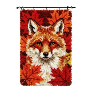 May include: A rectangular latch hook wall hanging featuring a detailed portrait of a fox with orange, white, and brown fur. The fox is centered against a background of vibrant red, orange, and yellow maple leaves, suspended from a black rod.