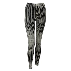 May include: Black leggings with a white vertical stripe pattern.