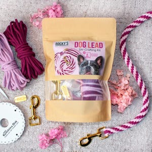 May include: DIY dog lead crafting kit with pink and purple cotton rope, a gold metal clasp, and a small tag that says "Rocky's". The kit includes instructions and a tutorial.