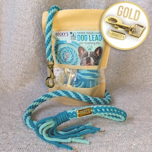 May include: A DIY dog lead crafting kit with a turquoise and green rope, a gold metal clasp, and a gold metal tag that says "ROCKY'S PET PRODUCTS". The kit comes in a clear plastic bag with a brown paper backing that says "MAKE YOUR OWN DOG LEAD DIY CRAFTING KIT".