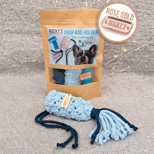 May include: A DIY poop bag holder crafting kit with a light blue and dark blue rope, a light blue crocheted bag, and a brown tag that says "ROCKY'S PET PRODUCTS". The kit comes with instructions and a tutorial. The kit is packaged in a brown paper bag with a picture of a French Bulldog on the front. The bag is labeled "ROCKY'S PET PRODUCTS POOP BAG HOLDER DIY Crafting Kit with step-by-step tutorial".