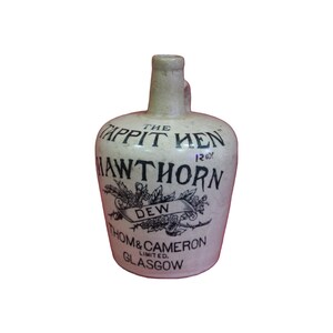 May include: A white ceramic jug with black lettering that reads "The Tappit Hen 120x Hawthorn Dew Thom & Cameron Limited Glasgow".