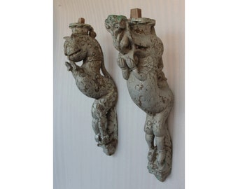 May include: Two antique wooden corbels carved in the shape of mythical creatures. The corbels are painted in a light gray color and have intricate details.