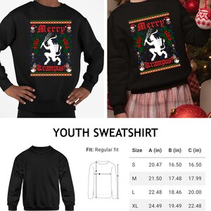 May include: Black youth sweatshirt with a Christmas-themed design featuring a Krampus figure and the text "Merry Krampus". The sweatshirt is available in sizes S, M, L, and XL. The size chart shows the measurements in inches for the chest, width, and length.