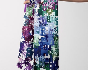 May include: A colorful scarf with a white background and a pattern of numbers and letters in shades of purple, blue, green, and teal. The scarf is held up, showcasing its design.