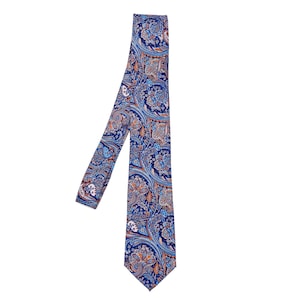 May include: A blue paisley patterned necktie with orange and white accents.