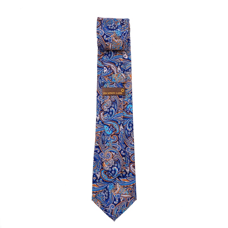 May include: A blue paisley patterned tie with orange and white accents. The tie has a label that reads "VOCATION LAND".