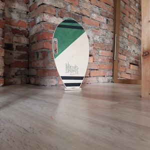 Surf style balance board a natural wooden roller covered with cork.