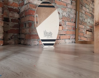 Surf style balance board a natural wooden roller covered with cork.