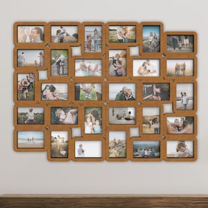 Puede incluir: Un marco de fotos de madera con una cuadrícula de 30 marcos individuales, cada uno con una foto de familia diferente. El marco está montado en una pared blanca sobre una cómoda de madera.