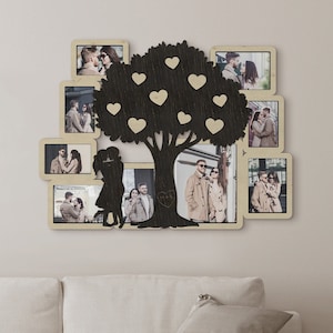 Personalized picture frame collage featuring a couple and a tree with hearts on it in the middle. This collage is 23 by 31 and has 9 frames. Frame and hearts can be painted in different colors. Initials can be engraved on the tree.