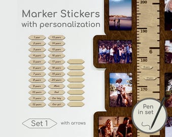 May include: Wooden growth chart with photo frames and marker stickers. The chart includes a ruler with measurements in centimeters, photo frames, and wooden marker stickers with ages and family member labels. The text "Marker Stickers with personalization" is at the top.
