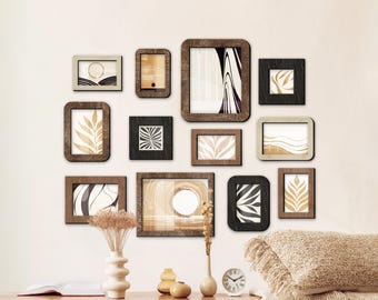 May include: A collection of framed art prints in various sizes and shapes, arranged on a wall. The frames are primarily wood-toned, with some black frames. The art prints feature abstract designs and botanical illustrations in neutral colors.