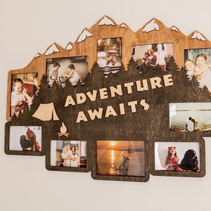 May include: A wooden photo frame with a mountain silhouette design. The frame has multiple openings for photos and the text "Adventure Awaits" in the center.