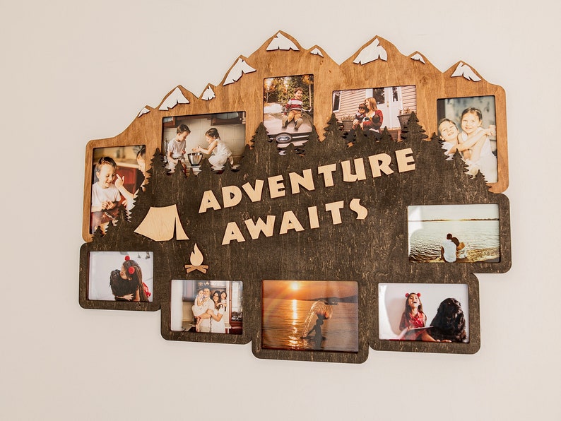 May include: A wooden photo frame with a mountain silhouette design. The frame has multiple openings for photos and the text "Adventure Awaits" in the center.