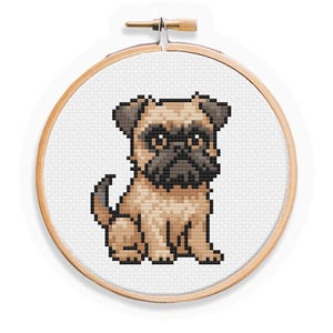 May include: A cross-stitch embroidery hoop featuring a pixelated pug dog. The dog is depicted in shades of tan, brown, and black, with a detailed, seated pose. The embroidery is set in a wooden hoop, creating a finished piece of art.