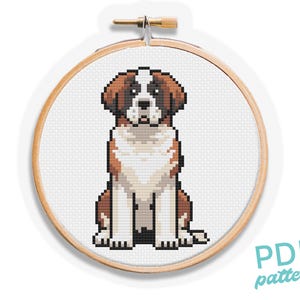 May include: A cross-stitch pattern of a Saint Bernard dog in a wooden embroidery hoop. The dog is depicted in brown, white, and black pixelated style. The text "PDF pattern" is in a teal script font.