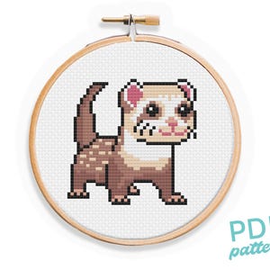 May include: A cross-stitch pattern of a ferret in a wooden embroidery hoop. The ferret is depicted in pixel art style, with brown, tan, and white colors. The text "PDF pattern" is in the lower right corner.