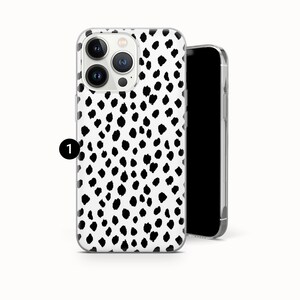 May include: A smartphone case featuring a white background with a repeating pattern of irregular black spots. The case has a cutout for a triple-lens camera system on the back. A black circle with the number 1 is positioned to the left of the case.