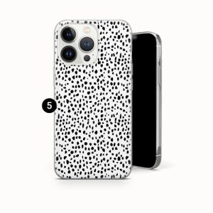 May include: A smartphone case featuring a white background with a dense pattern of irregular black spots. The case has a cutout for a triple-lens camera system on the back. A small black circle with the white number 5 is positioned on the left side.