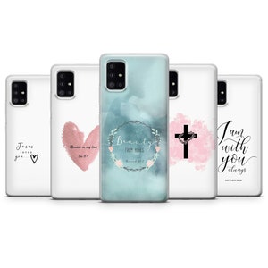 May include: Set of five phone cases with different Christian-themed designs. The cases feature watercolor backgrounds with pink and blue accents. The designs include a heart with the text "Remain in my love", a cross with a heart, a wreath with the text "Beauty from Ashes", and the text "I am with you always".