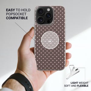 May include: A brown smartphone case with a white polka dot pattern. The case features a circular center area marked as easy to hold and PopSocket compatible. A smaller inset shows the case is light weight, soft, and flexible in construction.