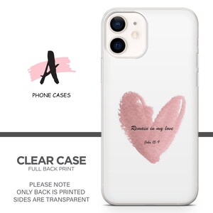 May include: Clear phone case with a pink watercolor heart design and the text "Remain in my love John 15:9".