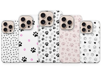 May include: Five different phone cases with paw print designs. The cases are clear and show the phone's camera lenses. The paw prints are black, gray, pink, and black with hearts.