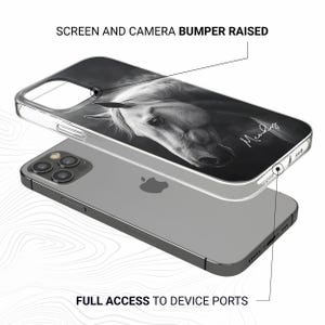 May include: Clear phone case featuring a black and white image of a horse's head. The case has the text "Screen and Camera Bumper Raised" and "Full Access to Device Ports". The horse image has a signature in the bottom right corner.