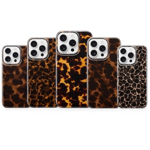 May include: Five smartphone cases arranged in a row, each featuring a distinct brown, black, and amber tortoiseshell or animal print pattern. Each case has a clear cutout for a triple-lens camera system and a white border around the lens array.