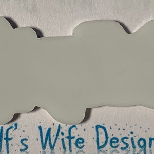 May include: A white, blank, vinyl sticker with a slightly irregular, cloud-like shape.