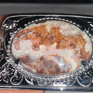 Crazy lace agate in a rectangular metal silver colored buckle has etched flowers and leaves big centerpiece