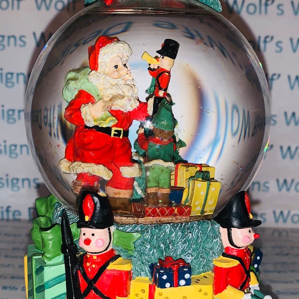 Christmas time snow globe. Santa and toys on base musical doesn’t play water low water stain on bottom