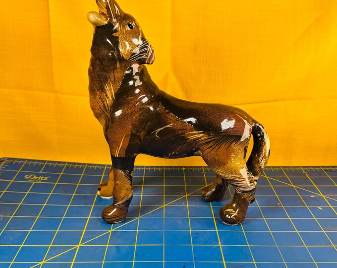 howling wolf figurine with what looks like safari sort of lion print to me not sure of the material necessarily but has a sort of glass feel