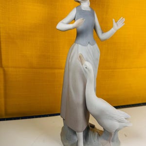 Lladro made in spain porcelain figure of a woman with a duck or goose handcrafted porcelain figurine in light shades bisque porcelain