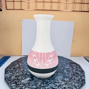 May include: A set of three ceramic mugs with a speckled, matte finish. The mugs are in shades of cream, light gray, and dark gray. Each mug has a simple, minimalist design, perfect for coffee or tea.