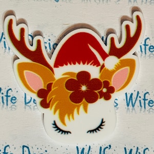 Christmas reindeer unicorn with Santa hat and flowers