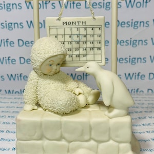 Snowbaby with penguin and calendar called worth waiting for the 9th is circled #56.69445